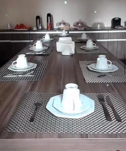 a table with plates and utensils in a kitchen at Pousada Villa Rica in Carolina