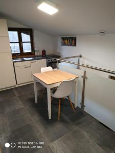 a kitchen with a wooden table and two chairs at Urlaub im schönen Nussdorf/Inn in Nußdorf am Inn
