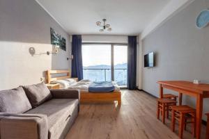 a living room with a couch and a table at Room310 in Gudauri