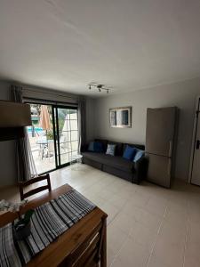un soggiorno con divano e frigorifero di Los Cancajos Apartamento Acijoa a Los Cancajos