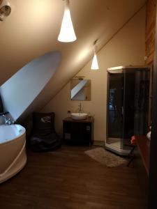 a bathroom with a sink and a shower and a toilet at Antalieptės sodyba 