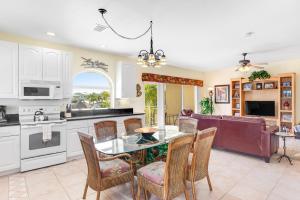 a kitchen and living room with a table and chairs at Captain's Haven in Key Colony Beach