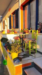 a patio with a table and chairs and plants at Viva Margarita in Parikia