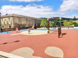 a playground with a slide and swings at Apartamento San Francisco in Viveiro