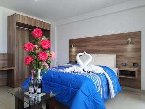 a bedroom with a bed with roses and a swan on it at PRIVATE ROOMS - DOWNTOWN AREQUIPA - GM Collection in Arequipa