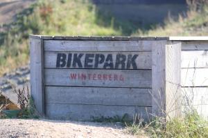 a wooden sign with the words bike parkwarning at Dein Winterberg Apartment - WIFI Geschirrspüler Smart TV in Winterberg