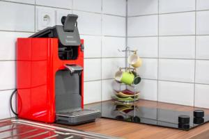 a kitchen with a red espresso machine on a counter at Appartement tout équipé à coté/Vieux port/Noailles in Marseille