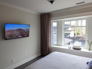 a bedroom with a bed and a large window at Nice home away at Vancouver near YVR in Vancouver