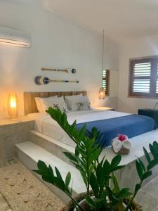a bedroom with a large bed with blue sheets at Pousada da Renata in Jericoacoara