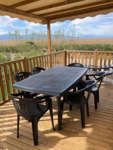 a black table and chairs on a deck at Mobil home 3 chambres mar estang 4 étoiles ! in Canet-en-Roussillon
