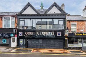 a building with a sign on the side of it at Luxury stay in EastwoodTown centre in Eastwood