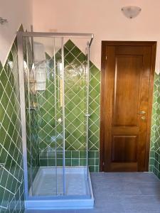 a shower with a glass door in a bathroom at 502 Porto Cervo Apartment in Liscia di Vacca +18 photos