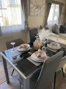 a dining room table and chairs with a table and chairsktop at Beautiful Spacious Holiday Home - Romney Sands in New Romney