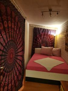 a bedroom with a bed with a red blanket and a curtain at FREEDOM 2 in Gornji Štoj
