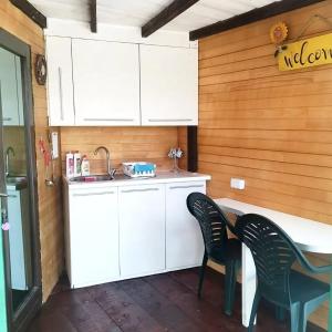 a kitchen with white cabinets and a table and chairs at FREEDOM 2 in Gornji Štoj