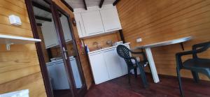 a small kitchen with a table and a chair at FREEDOM 2 in Gornji Štoj +5 photos