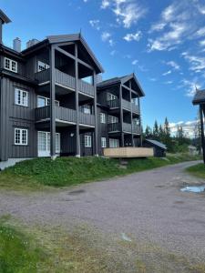 un edificio de apartamentos con balcones al lado de una carretera en Leilighet i Fageråsen i nærheten av Høyfjellssenteret med sengeplass for 4-7 personer en Trysil