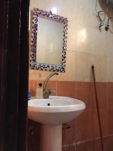 a bathroom with a sink and a mirror at Dahab house apartment 2 in Dahab +1 photo