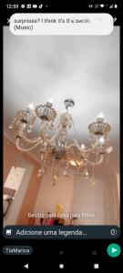 a picture of a chandelier on a website at Apartamento novo Gran Safira in Itapema