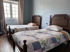 1 dormitorio con 2 camas y ventana en Fernando Guest House, en Aveiro