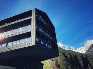 a building with a view of a mountain at Amus Suites Dolomites in Anterselva di Mezzo