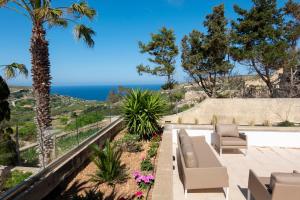 a patio with a view of the ocean at VillaNirvana in Qala