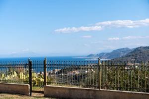 a view of the ocean from behind a fence at Gustav Retreat Villa in Goumaíika