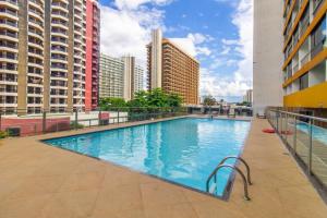 a large swimming pool on a building with tall buildings at GARVEY FLAT in Brasilia