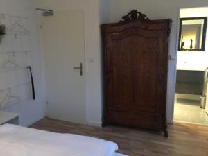 a bedroom with a large wooden door and a bed at Gaestehaus Denecke in Scharbeutz