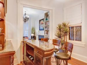 a kitchen with a table and chairs in a room at The Lyons House - Luxe Historical Home - Parking Included in Savannah