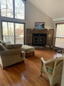 a living room with a couch and a fireplace at Chalet in The Woods in Hedgesville