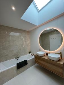 a bathroom with two sinks and a large mirror at Maison Terracotta vous accueille à 8min de Dinard in Le Minihic-sur-Rance +21 photos
