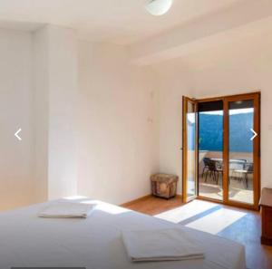 a bedroom with a bed and a view of a table at Crikvenica Villa Vanja in Kostelj