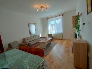 a living room with a couch and a table at 2-iz. byt v tichej lokalite s bezplatným parkovaním in Liptovský Hrádok
