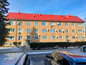 a large orange building with a red roof at 2-iz. byt v tichej lokalite s bezplatným parkovaním in Liptovský Hrádok