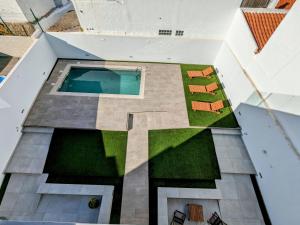 an overhead view of a house with a pool and lawn at Ria Breez'in by JohnVillas in Alvor