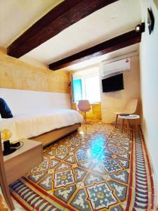 een kamer met een bed en een tapijt op de vloer bij Cove 532 by Savynomad Harbour Residences wow View in Valletta
