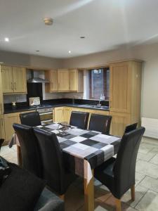a kitchen with a table and chairs in a kitchen at Meadow View in Moneymore