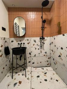 a bathroom with a sink and a mirror at Heart & Cherry Residency in Budapest