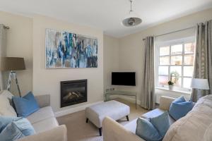 a living room with a couch and a fireplace at The Old School House, Winchester in Winchester