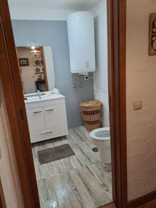a bathroom with a white sink and a toilet at Labruge Ocean View in Labruge