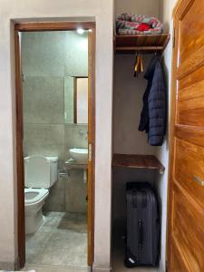 a bathroom with a toilet and a sink at Hospedaje Fortaleza Indigena in Tilcara