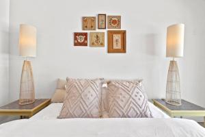 a white bed with two lamps on top of it at Funky Pool Side Cabana in DTPHX in Phoenix