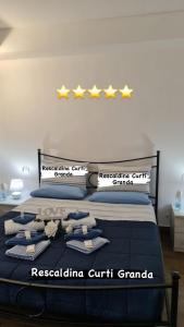 a bedroom with a bed with five stars on it at Curti Granda in Rescaldina