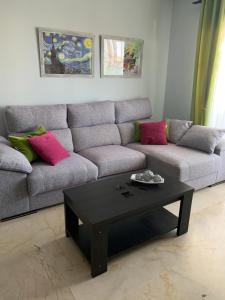 a living room with a couch and a coffee table at Residencial Duquesa Fase 1 in Manilva