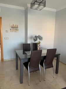 a dining room with a table and chairs at Residencial Duquesa Fase 1 in Manilva