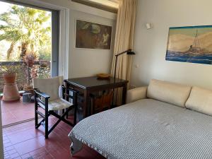 a bedroom with a bed and a desk and a table at Argyro suite Rafina in Rafina