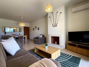 a living room with a couch and a coffee table at Golf Villa Alvor By CORAL in Alvor