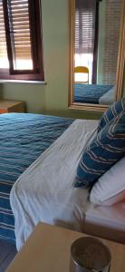 uma cama com almofadas azuis e brancas num quarto em INTERNO 12 em Vercelli