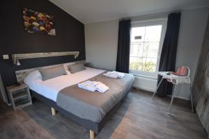 Postel nebo postele na pokoji v ubytování Vakantiepark de Meerpaal
